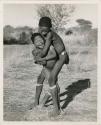 "Boys' play": Gao (son of ≠Gao and Khwo//o-/Gasa) standing with his arms around another boy (print is a cropped image)