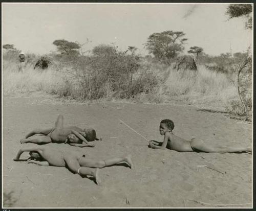 "Boys' play": Four children rolling on the ground in a cleared area where dances take place (print is a cropped image)