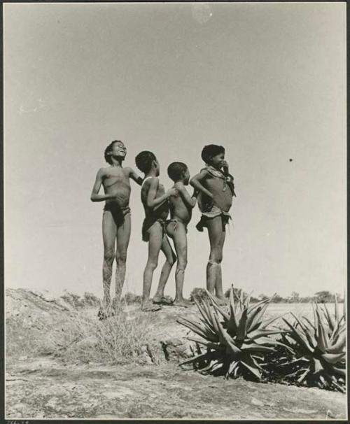 "Boys' play": Four boys standing (print is a cropped image)