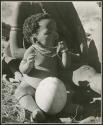 "Children": Baby (child of ≠Gao, leader of Band 10, and Bau, his first wife) sitting next to an ostrich eggshell (print is a cropped image)