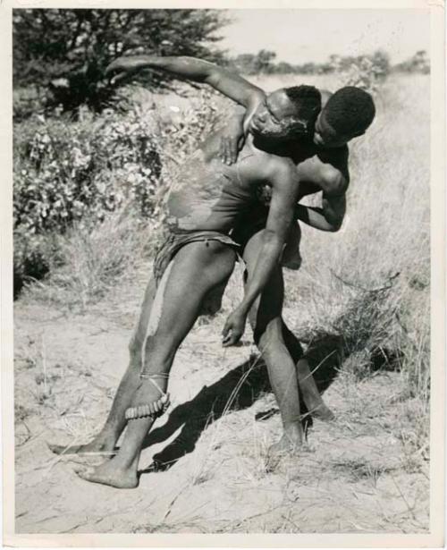 "Children": Medicine man falling backwards into the arms of another man (print is a cropped image)