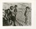 "Photos of Children": Debe, crying, /Gaishay, Bau, !Ungka Norna standing to the right, and other unidentified people; part of Elizabeth Marshall Thomas's child study (print is a cropped image)