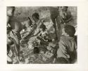 "Photos of Children": !U, !Unkga Norna playing with a digging stick, ≠Toma, /Gaishay (Toma and ≠U's son) to the left, Tsamgao standing behind !Unkga Norna, their grandmother in the background, and "Gao Lame" wearing a headscarf; part of Elizabeth Marshall Thomas's child study (print is a cropped image)