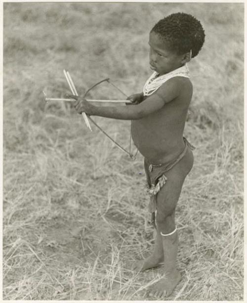 /Gaishay ("Gao Medicine" and Di!ai's son) with a toy bow and arrow, pulling back the string to release an arrow (print is a cropped image)
