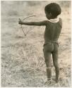 /Gaishay ("Gao Medicine" and Di!ai's son) with a toy bow and arrow, pulling back the string to release an arrow, view from behind (print is a cropped image)