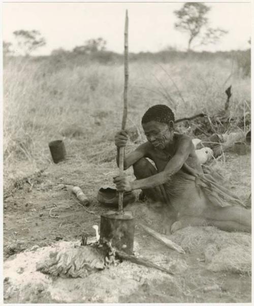 /Naoka (!U's mother) stirring the contents of a pot with a stick (print is a cropped image)