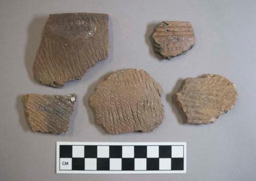 Ceramic, earthenware rim and body sherds, some cord-impressed, one incised, some shell-tempered, one grit-tempered