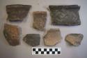 Ceramic, earthenware rim and body sherds, some incised, some incised and cord-impressed, one with missing handle, shell-tempered