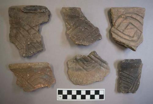 Ceramic, earthenware rim and body sherds, some incised, some incised and cord-impressed, one with missing handle, shell-tempered