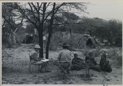 Three people sitting, Lorna Marshall and Wilhelm Camm sitting in chairs, interviewing them



