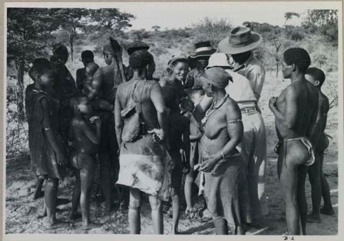 Group of men and women standing around Wilhelm Camm and Lorna Marshall



