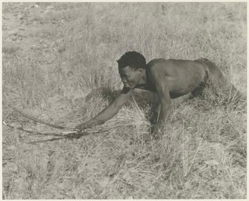 "Crooked /Qui" crawling, holding bow and arrow (print is a cropped image)