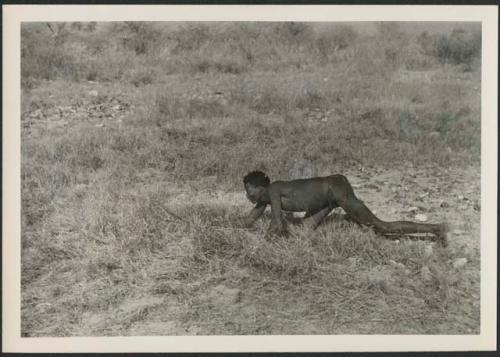 "Crooked /Qui" crawling, holding bow and arrow (print is a cropped image)