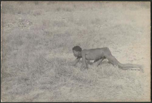 "Crooked /Qui" crawling, holding bow and arrow (print is a cropped image)