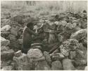 "Crooked /Qui" in shooting position in hunting blind built of stone (print is a cropped image)