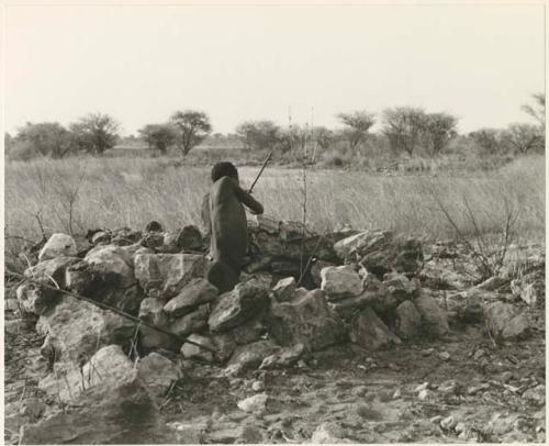 "Crooked /Qui" rising to his knees to shoot in hunting blind (print is a cropped image)