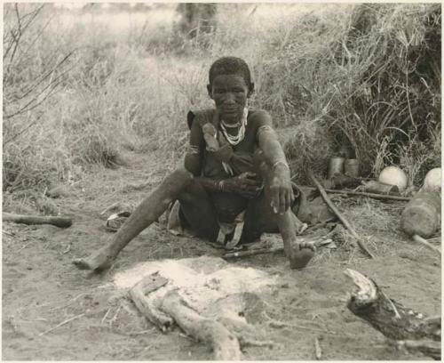 Portrait of "Old Xama," mother of "Gao Beard," sitting beside her fire (print is a cropped image)