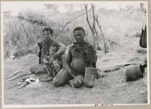 ≠Gao (Headman of Band 3; son of /Gasa) with his unidentified wife and child, all seated (print is a cropped image)