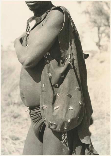 Man wearing a breechclout, bag ornamented with beads, and small kaross (print is a cropped image)