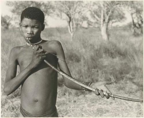 !Naishi (brother of /Goishay) playing a musical bow (print is a cropped image; image is flipped)