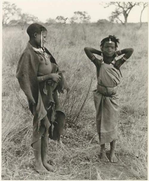 "Visiting girl" and a younger girl standing, with a cloth wrapped around herself as a garment (print is a cropped image)