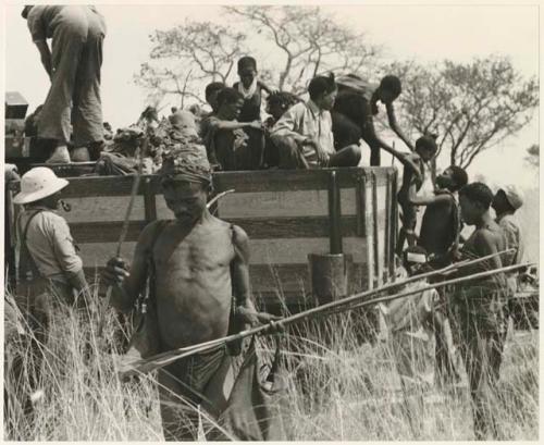 Ju/'hoansi getting off a truck (print is a cropped image)