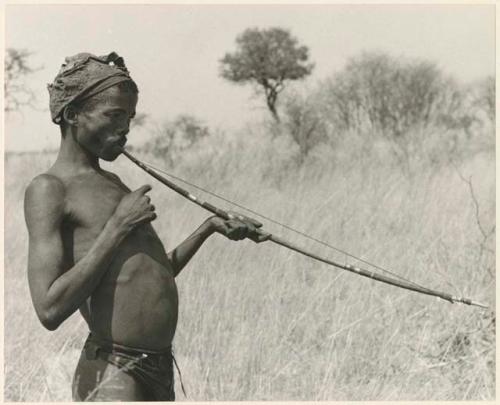 "/Gao Music" playing a musical bow (print is a cropped image)