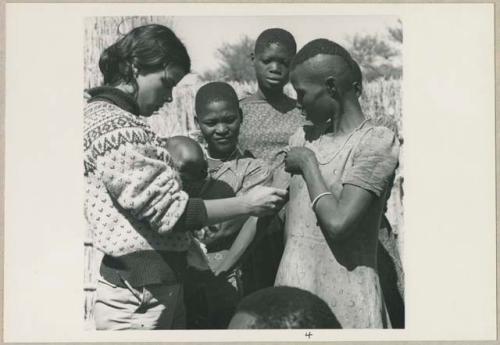 Woman having her skin color documented by Deborah Marshall (print is a cropped image)