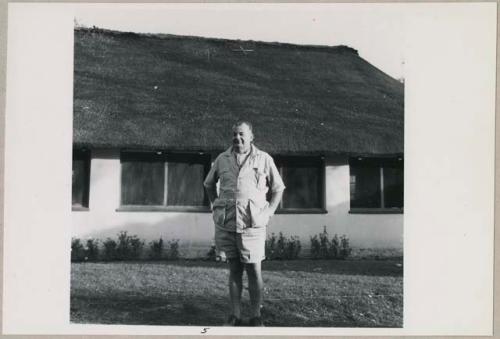 C. J. Mathias standing in front of his house (print is a cropped image)