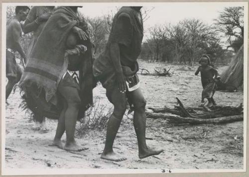 N//aba, !Xoa, and a man holding eland horns walking counter-clockwise, performing the Eland Dance, seen from the ground (print is a cropped image)