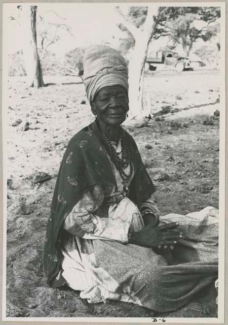 Portrait of an elderly woman sitting (print is a cropped image)