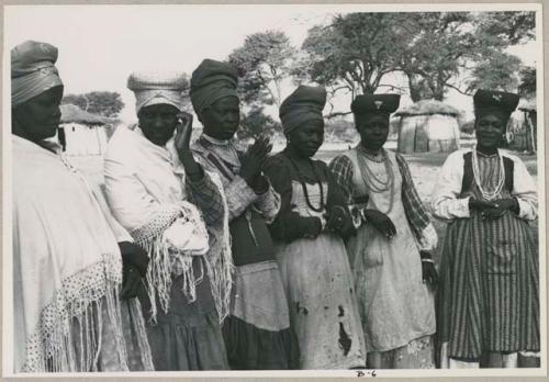 Women standing in a line (print is a cropped image)