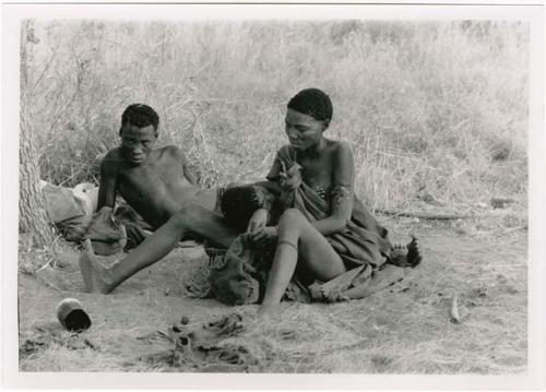 "Misc. prints with no numbers": //Khuga nursing her daughter, Bau, and her husband "Crooked /Qui" sitting beside her (print is a cropped image)