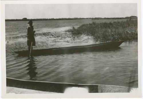 "1950 - 300 series duplicates": Man poling a boat along the Okavango River