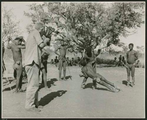 [No folder]: Medicine man falling in trance, caught by another medicine man, with John Marshall filming them (print is a cropped image)