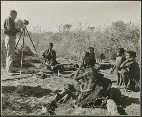 [No folder]: Group of women sitting, including !Ungka, her sister //Kushay and /Naoka (wife of "/Qui Hunter" of Band 2), with John Marshall filming them (print is a cropped image)