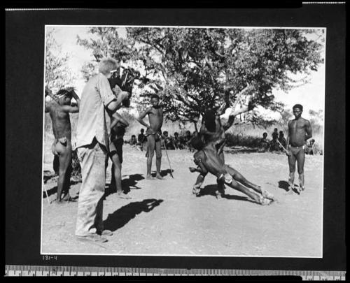 [No folder]: Medicine man falling in trance, caught by another medicine man, with John Marshall filming them