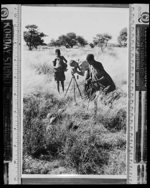 [No folder]: /Twikwe and DaSi!Na standing beside John Marshall while he films