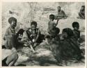 Group of people participating in a choa ceremony (print is a cropped image)