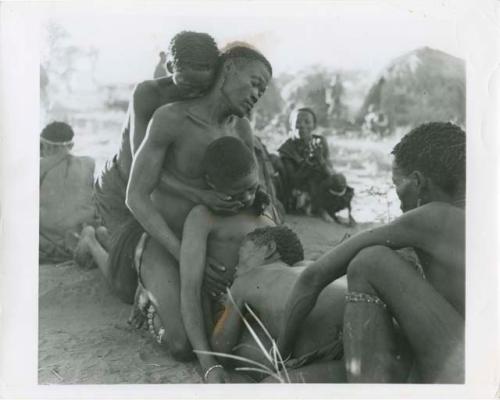 Four men collapsed in trance after aiding /Gunda, at a daytime dance (print is a cropped image)