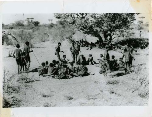 People dancing, shows changing direction with men going in both directions (print is a cropped image)