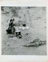 /Naoka (first wife of "Gao Medicine") cooking ostrich eggs in an Ovambo pot (print is a cropped image)