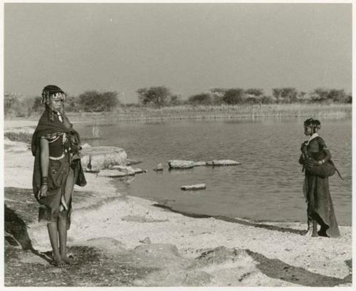 !Ungka's cousin, standing, holding a tin and an unidentified girl and Nama Pan in the background (print is a cropped image)