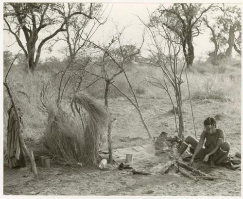 Woman sitting in her living space (print is a cropped image)