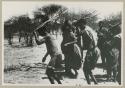 [No folder title]: /Gaishay and Tchobe, the husband of ǂKxoba, wearing horns and dancing, performing the Eland Dance (from color slide 2001.29.8664)