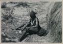 [No folder title]: Woman sitting washing herself from a bowl
