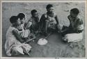 Group of young women sitting, playing a dandiri and singing