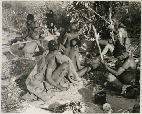 [No folder title]: Group of people sitting, eating tsama melons