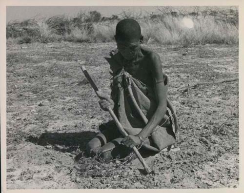 [No folder title]: /Twikwe clearing ground with a digging stick


