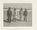 "1950's 400 series": Four men standing on a beach (print is a cropped image)